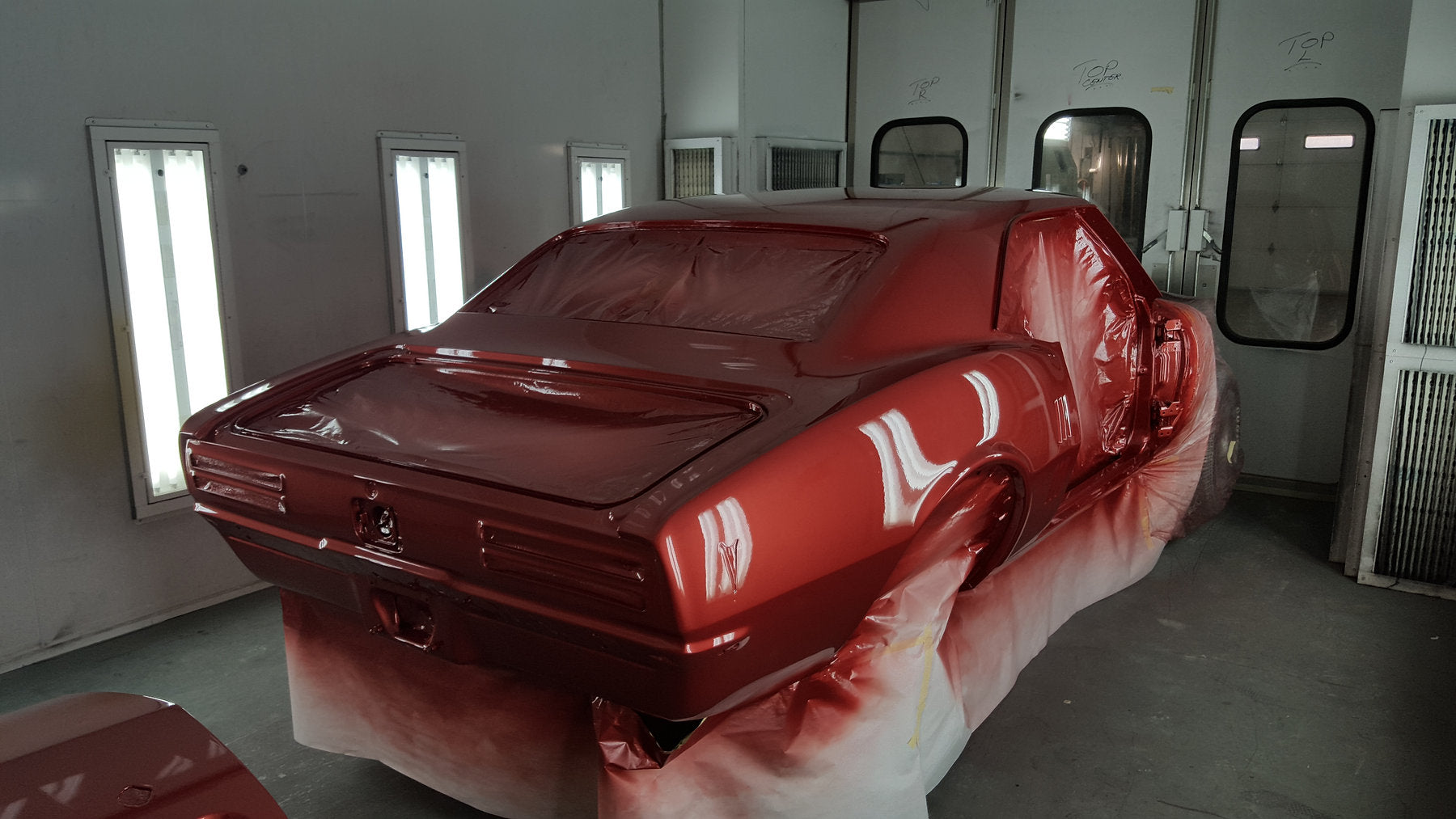 Classic car receiving paint in the Top Secret paint booth