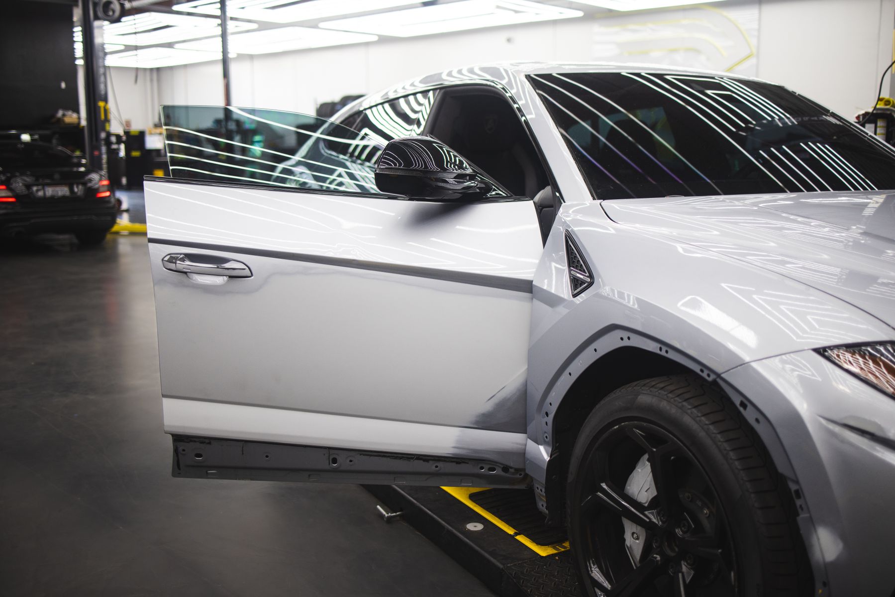 Modern sedan undergoing automotive service