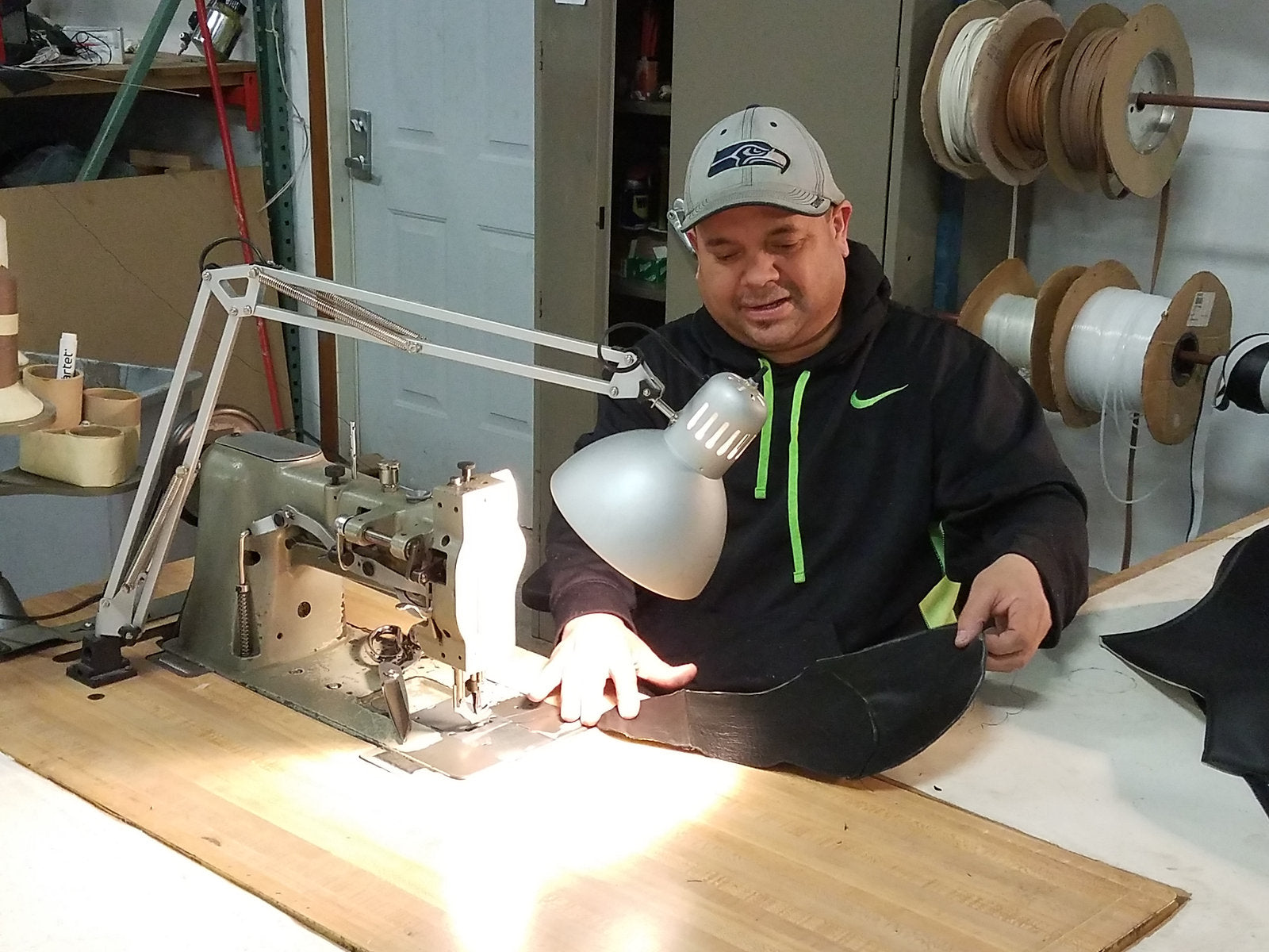 Top Secret upholstery craftsman sewing a custom interior